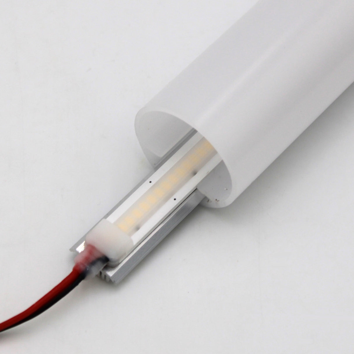 A close-up of the Flat Bar Aluminum Heatsink LED Profile ~ Model Yukon, showing an LED strip inside its translucent cover with red and black wires at one end, all set against a plain white background.
