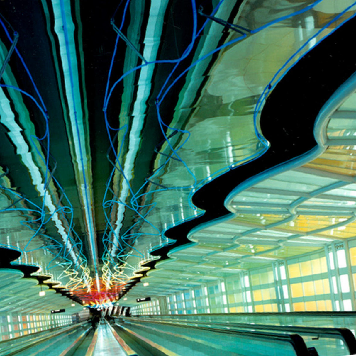A futuristic airport walkway features colorful neon lights with wavy reflections, lined with ALPOLIC/RF Series reflective aluminum composite panels in green, blue, and yellow for a striking, high-reflectivity look.