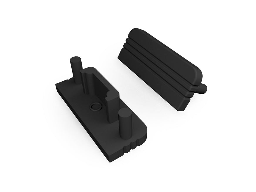 Two black plastic End Caps for the Surface10 Profile, featuring cylindrical pegs and grooves, are displayed separately on a white background as if ready to be connected. These components act as essential LED accessories by capping the ends of the Surface10 LED channel.
