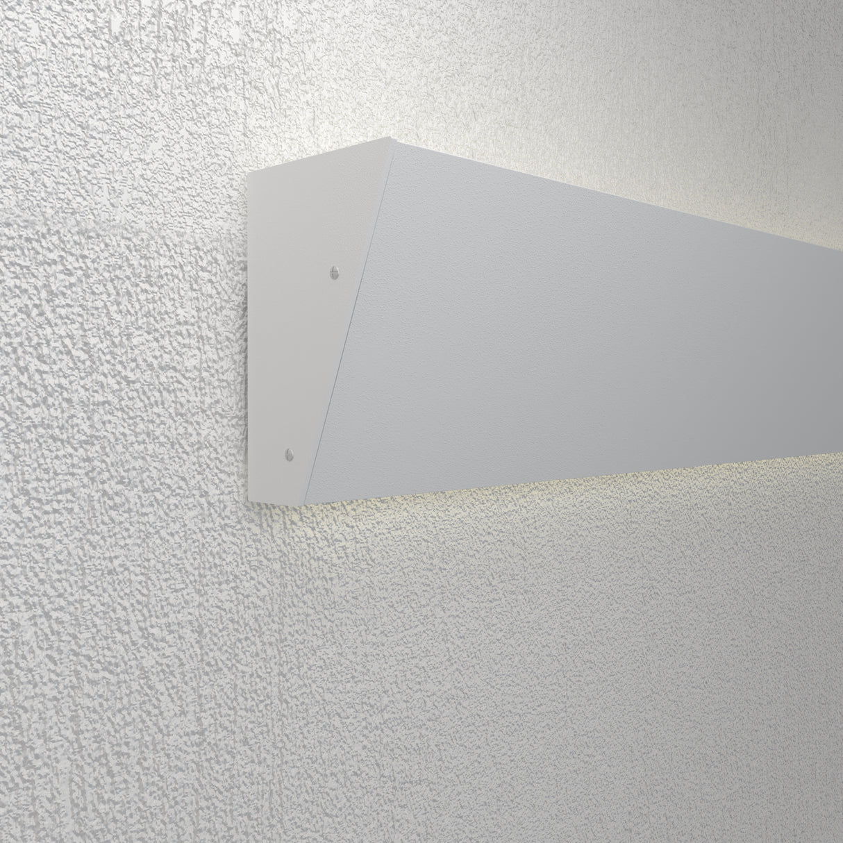 The Up and Down Ceiling Wall Wash LED Profile ~ Model Badalona is a modern, minimalist white fixture with a triangular side profile, mounted on a textured wall, delivering soft, balanced indirect lighting both upward and downward.