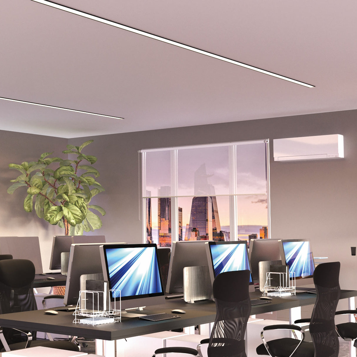 A modern office with multiple computer workstations, black chairs, and a large plant features Shallow Ceiling Recessed LED lighting Chanel ~ Model Amara, which enhances the organized space as sunset city views fill the room with warm light.