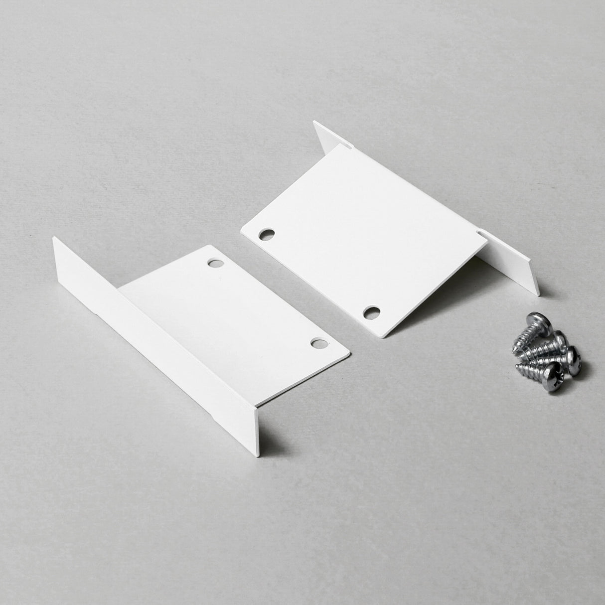 Two white Metal End Caps for Phil Recessed Profile, shown flat on a light surface with silver screws—ideal for completing your lighting fixture.