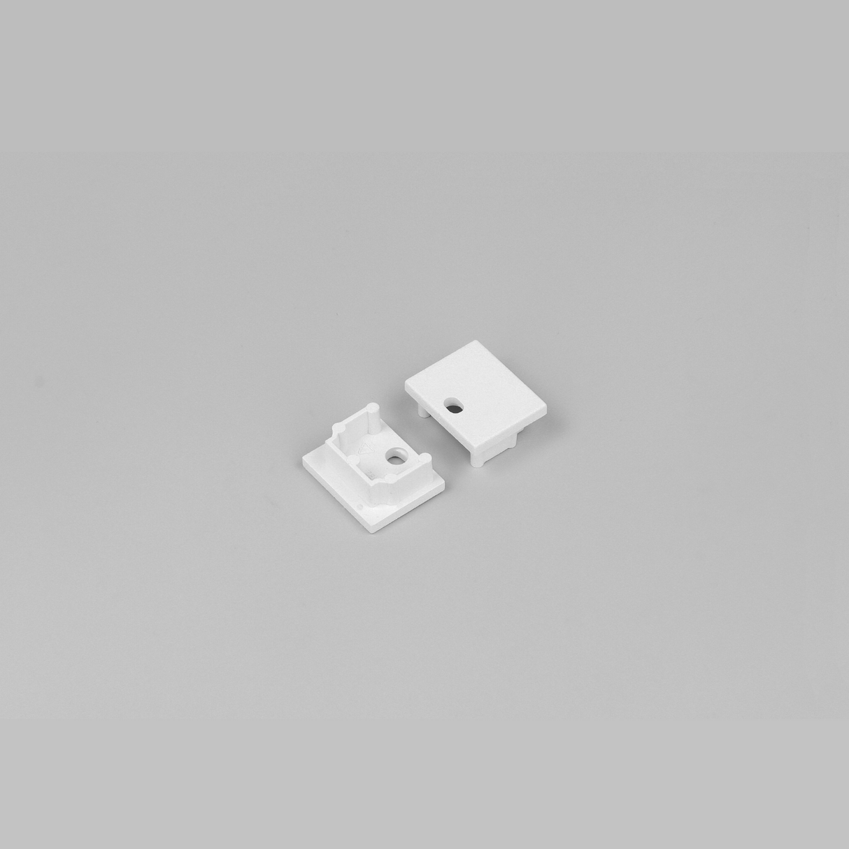 Two End Caps for Plane14 Profile, small white rectangles made of ABS with a hole and cutouts, are displayed on a plain light gray background.