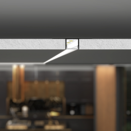 A modern ceiling uses the Plaster-In Trimless Plasterboard LED Profile ~ Model Plane14-In, a narrow recessed aluminum fixture that emits a sharp beam, illuminating part of a contemporary space with dark walls and wooden accents below.