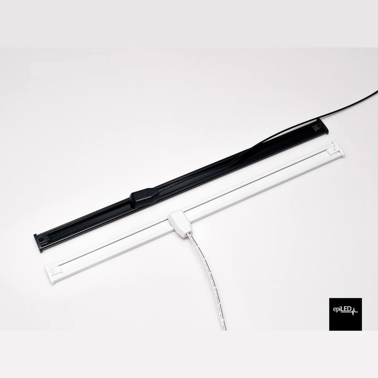 Two slim LED fixtures, one black and one white, sit side by side on a white surface with power cords and Power Track Twist Plug Connectors attached. The white light bar has a visible switch, and the epiLED logo is at the bottom right.