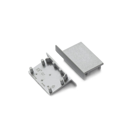 Two small End Caps for Vario30-07, made of gray plastic with raised edges and pegs, are shown side by side on a white background.