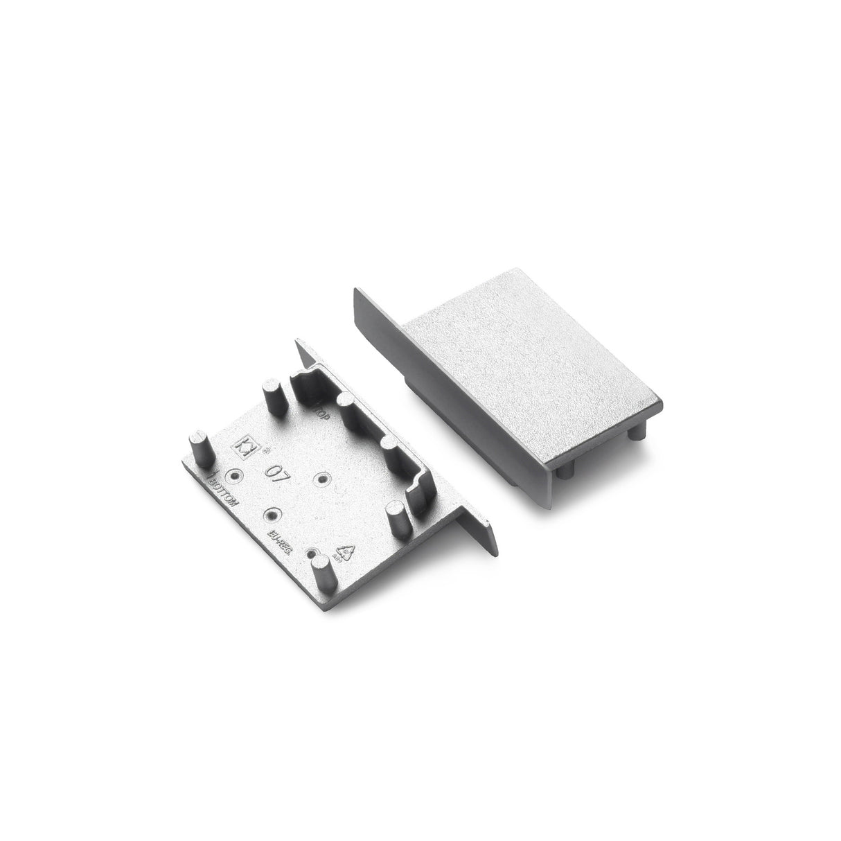 Two rectangular End Caps for Vario30-07, featuring raised tabs and pegs, are shown side by side on a white background—one flat, one upright. Perfect for securely attaching to the Vario30-07 profile.