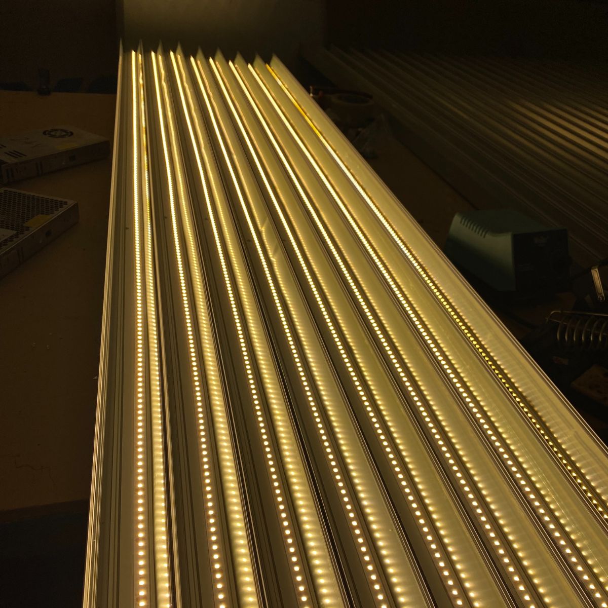 Rows of bright, warm white LED strips are placed in parallel on the Light Reflector 32mm Vega95, producing a glowing pattern in a dim space. The reflector is compatible with DPL55-FL, DPL70-FL, PL55-FL, PLW70-FL, RPL55US, RPL70US and RPLW80FL.
