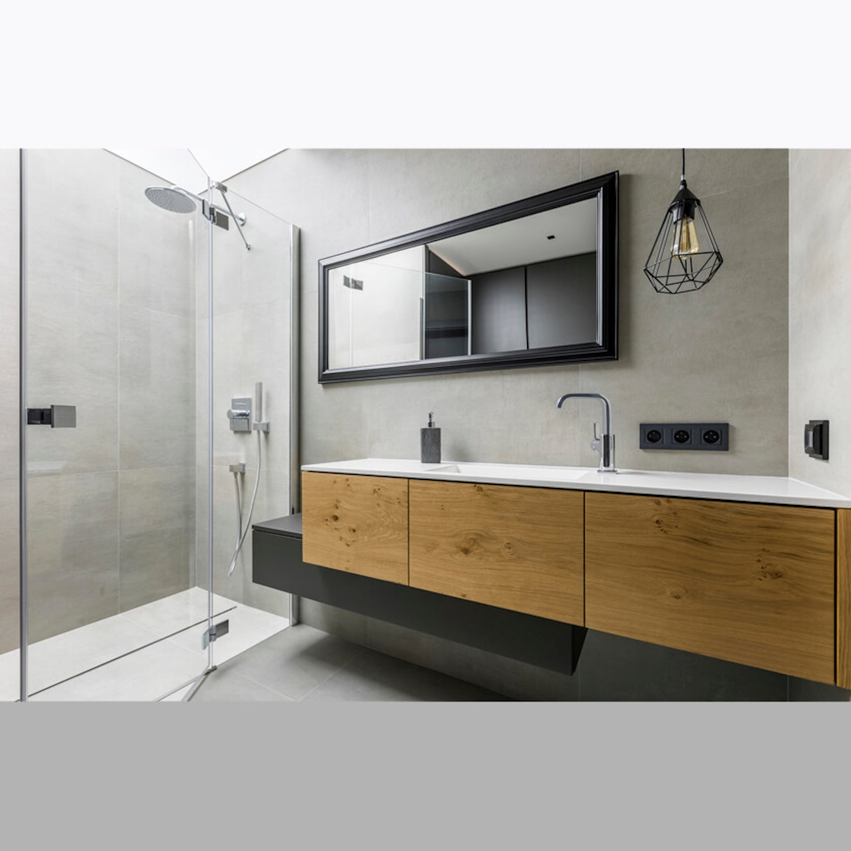 Modern bathroom with a glass shower, rectangular mirror, wooden floating vanity, gray walls, pendant light, and minimal decor—all conveniently managed using the wireless switchBoxDC by Blebox for effortless control.