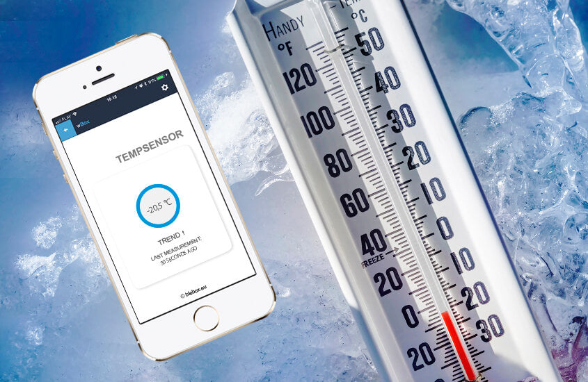A smartphone with the wBox app shows a -20.5°C reading from the Smart Wireless Temperature Sensor ~ tempSensor by Blebox, next to a large analog thermometer, both surrounded by ice for accurate monitoring.