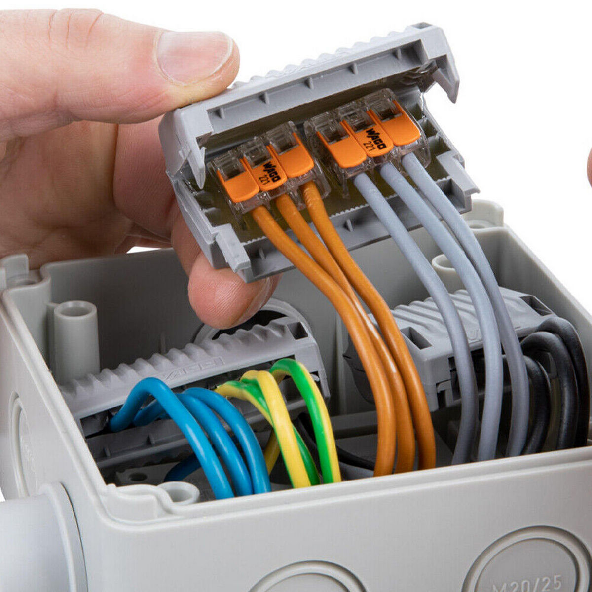 A hand lifts a terminal block with orange levers, like those used in the Waterproof Sealing Gelbox for Wago 221 Splicing Lever-Nut Connectors, which is wired inside a gray electrical junction box.