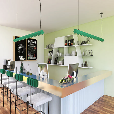 A modern café features a sleek counter, high stools, green hanging lights, and open shelves with kitchenware. The Precoated LED Hexagon Light Channel ~ Model Paco highlights the chalkboard menu on the pale green wall behind the counter.