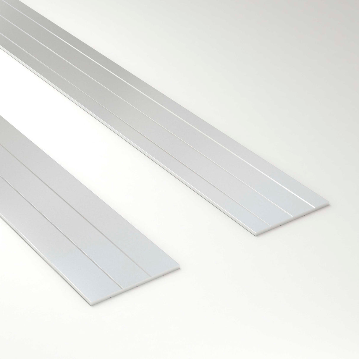 Two flat, rectangular metal Inner Plates for Ricardo Profile, each with grooved lines along their length, are positioned side by side on a light surface, resembling components used for heat dissipation in LED channel systems.