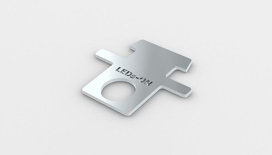 A small, flat, metallic Removing insert profile key for RPL55 led profile with a rectangular shape, circular hole near one end, and LEDS-ON engraved on the surface, made in Europe, shown on a plain white background.