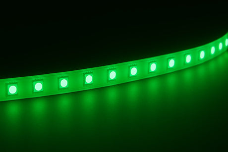 A single-color LED strip on a dark background shining onto a reflective surface.