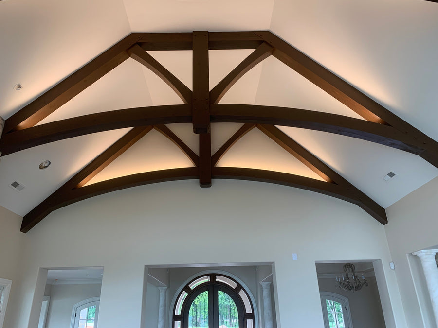 Barrel vaulted ceiling with indirect LED lighting around timber beams