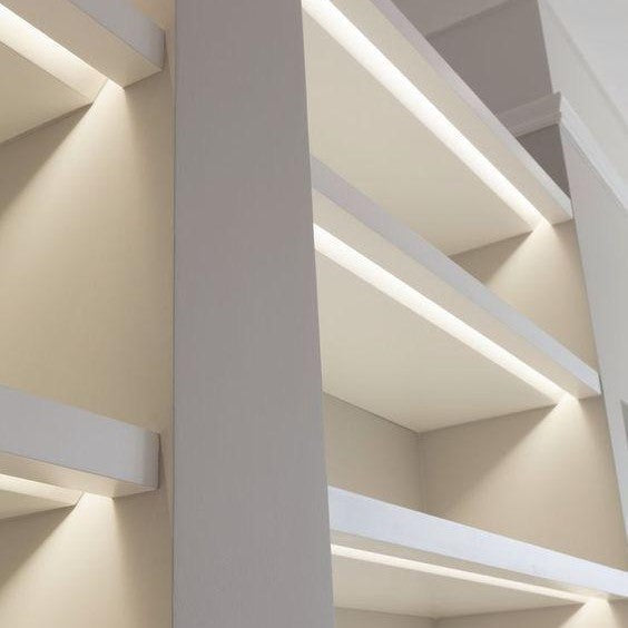Integrated linear LED lighting in modern bookshelf shelving