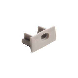 The End Cap for Milano Slim Profile is a compact, light gray plastic accessory with a central slot and two parallel prongs at the back, designed to fit Milano Slim Profile lighting fixtures.
