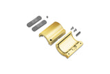 A brass-colored metal through holder for the Arc12 Duo Profile is disassembled into two halves, accompanied by two rectangular gray pieces, one small round component, two screws, and a pin—all parts neatly arranged on a white background.