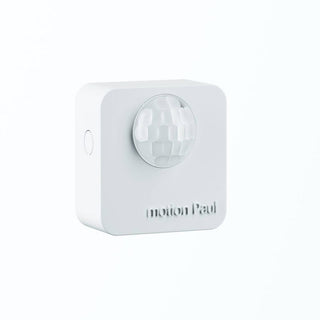 A white, square Battery Powered Motion Sensor for Casambi Lighting (Estol Motion Paul) with a rounded lens, designed for energy-saving automatic lighting control. Motion Paul is embossed below the lens and it’s mounted on a white background.