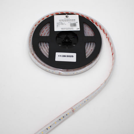 A roll of Low-Power RGBW IP67 Waterproof LED Strip (24V) ~ Iris Series is shown on a black plastic spool with a white label dated 11/28/2025, with the LED strip extending from the reel against a white background.