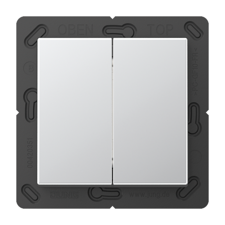 A close-up of the Casambi 4-Channel Wireless Radio Transmitter (Jung BLE A 595) shows two rectangular white buttons on a black frame labeled OBEN and TOP, featuring Bluetooth Low Energy for smart connectivity.