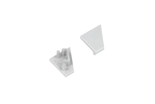 Two small, light gray, triangular plastic End Caps for the Corner10.v2 Profile—one oriented upward to reveal a smooth surface, the other inverted to display pegs and notches on the underside—sit against a white background. These components are designed specifically for use with the Corner10.v2 Profile lighting fixture, providing a clean and secure finish.