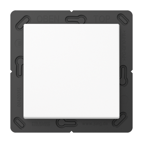 The Casambi 2-Channel Wireless Radio Transmitter, Model Jung BLE A 590, is a white square switch plate centered on a black bracket with rounded corners and visible screw holes, featuring wireless control and OPEN/TOP labels at the top.