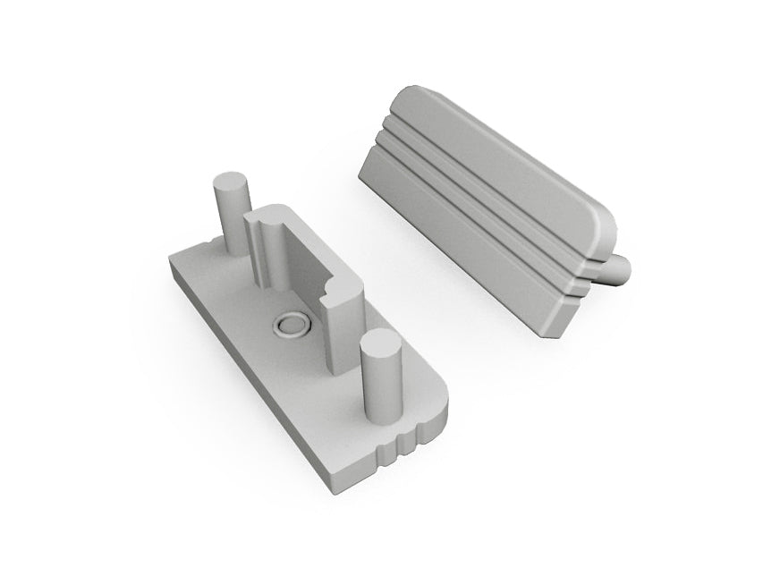 Two gray plastic components—an End Cap for Surface10 Profile, which is rectangular with cylindrical pegs and a central hole, and an angled cover with ridges—are shown on a white background. Both items serve as LED accessories for the Surface10 LED channel.