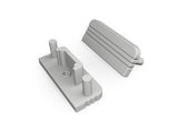 Two gray plastic components—an End Cap for Surface10 Profile, which is rectangular with cylindrical pegs and a central hole, and an angled cover with ridges—are shown on a white background. Both items serve as LED accessories for the Surface10 LED channel.