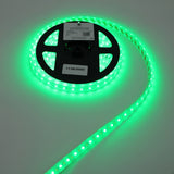 A spool of Low-Power RGBW IP67 Waterproof LED Strip (24V) ~ Iris Series glows brightly on a white surface, with a label showing a barcode and date attached to the reel.
