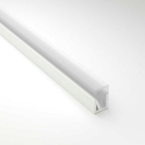 The Flexible LED Neon Light Silicone Profile, Model Neon Las Vegas, is a white silicone diffuser channel with a frosted cover. Its rectangular design ensures even light distribution, ideal for decorative lighting against a plain gray background.