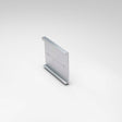 The Mounting Clip for Badalona Profile is a metallic, rectangular aluminum bracket with top and bottom flanges, a smooth finish, and two central screw holes, displayed against a plain light background.