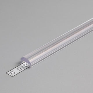 The LED Channel Cover ~ C Click Lens, made of clear plastic, is partially open to reveal the LED strip inside, placed on a plain gray surface.