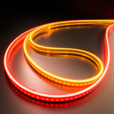 Curved strips of the Color IP44/IP66 Neon Flexible LED Light Line (24V) ~ Flex Ultra Slim Series glow on a dark, reflective surface, forming an abstract teardrop or loop pattern with continuous dotless illumination.