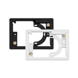 Two rectangular plastic framePanelM wall mount frames for controlPanelM screens by BleBox, one black and one white, are shown overlapping. Each frame features circular and rectangular cutouts, screw holes, and small metal contact points on their surfaces.