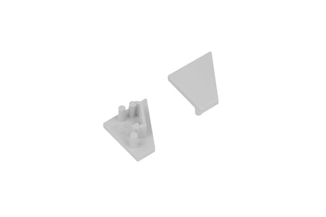 Two light gray triangular End Caps for the Corner10.v2 Profile lighting fixture are arranged on a white background—one positioned with its smooth surface facing up, and the other flipped over to display its connectors and studs.