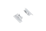 Two small, rectangular, silver metal End Caps for Groove10.v2 Profile with raised edges and cylindrical posts are positioned on a white background facing each other.