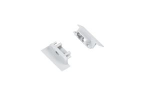 Two small, rectangular, silver metal End Caps for Groove10.v2 Profile with raised edges and cylindrical posts are positioned on a white background facing each other.