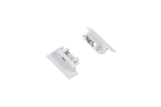 Two small, rectangular, silver metal End Caps for Groove10.v2 Profile with raised edges and cylindrical posts are positioned on a white background facing each other.