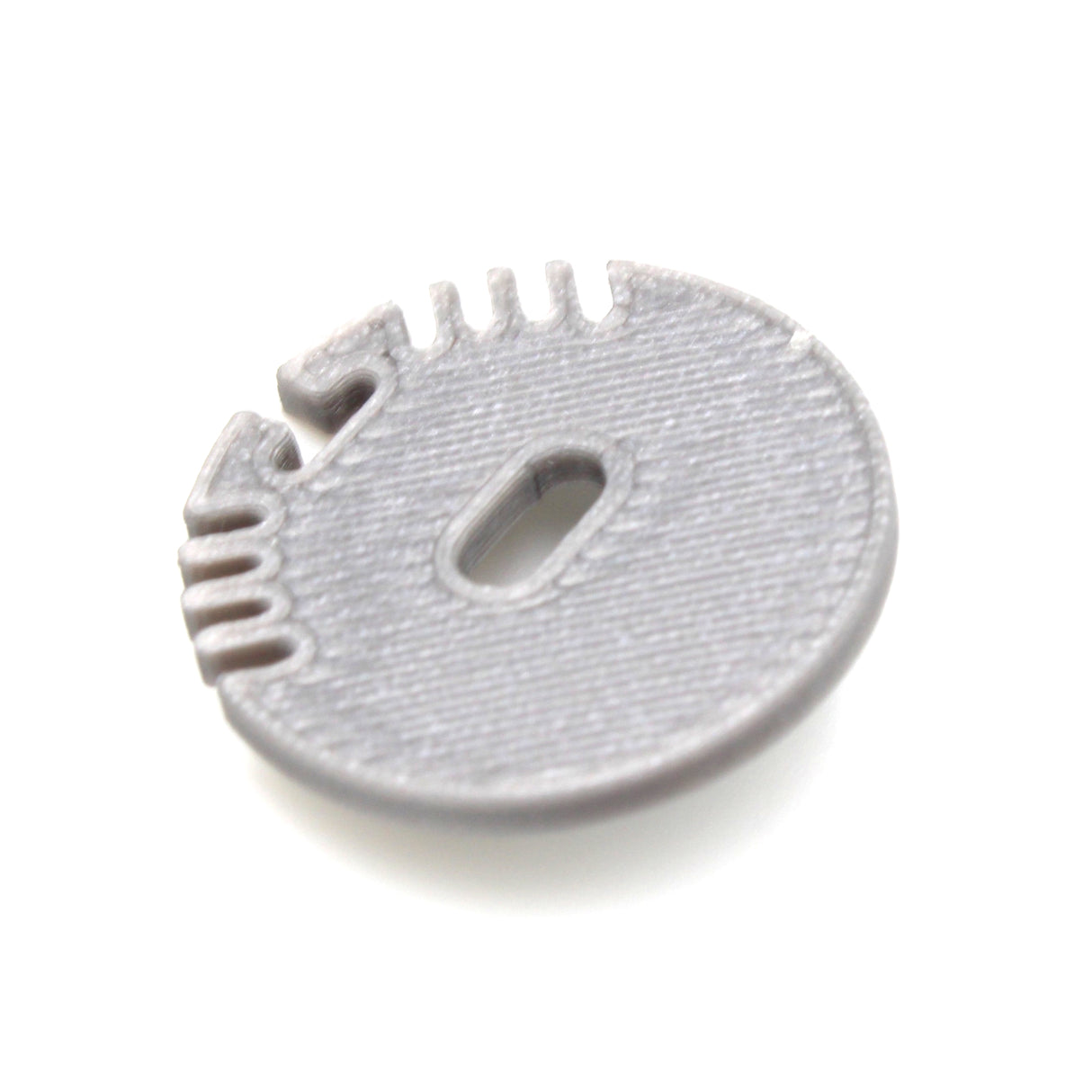 A gray, round plastic End Cap for Alu Round Profile with ridges, a central oval cable hole, and several small edge notches, shown on a white background.