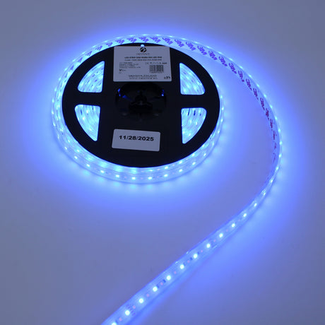The Iris Series Low-Power RGBW IP67 Waterproof LED Strip (24V) shines brightly with blue light on a white surface while maintaining energy efficiency.