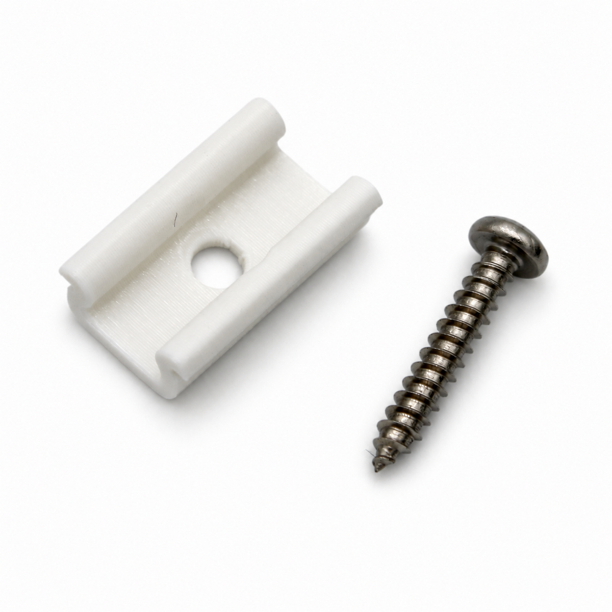 A white 3D printed Mounting Clip for Galicia Profile featuring a center screw hole, positioned next to a metal wood screw.