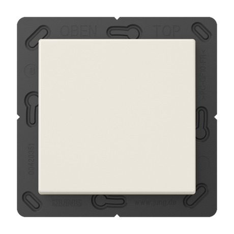 A white, square Casambi 2-Channel Wireless Radio Transmitter (Model Jung BLE A 590) light switch is mounted on a dark gray rectangular plate labeled OBEN and TOP at the top, with technical markings along the sides.