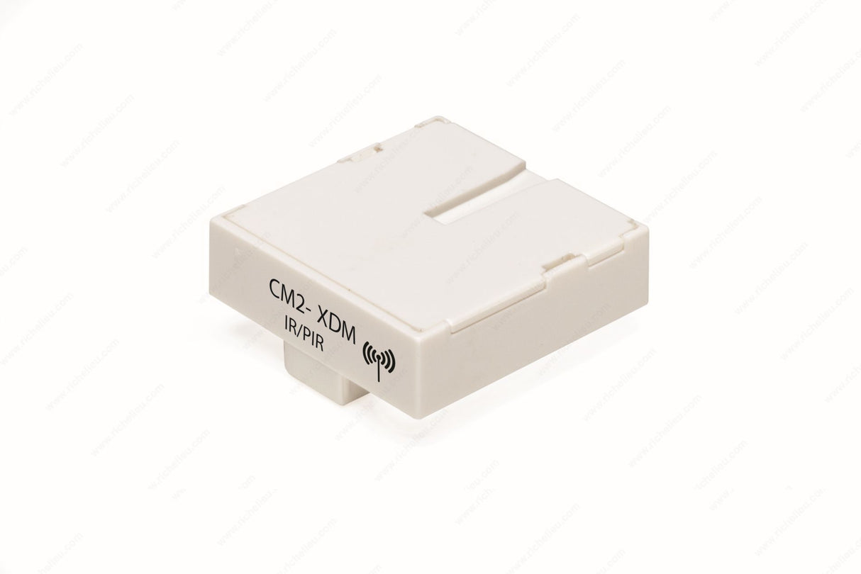 A compact, rectangular white module labeled "CM2-XDM D-Motion" with a wireless icon. The Remote Controller Module & Wireless IP/PIR Sensor is ideal for LED luminaires control and features a minimalistic, smooth-edged design.