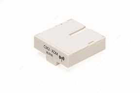 A compact, rectangular white module labeled "CM2-XDM D-Motion" with a wireless icon. The Remote Controller Module & Wireless IP/PIR Sensor is ideal for LED luminaires control and features a minimalistic, smooth-edged design.
