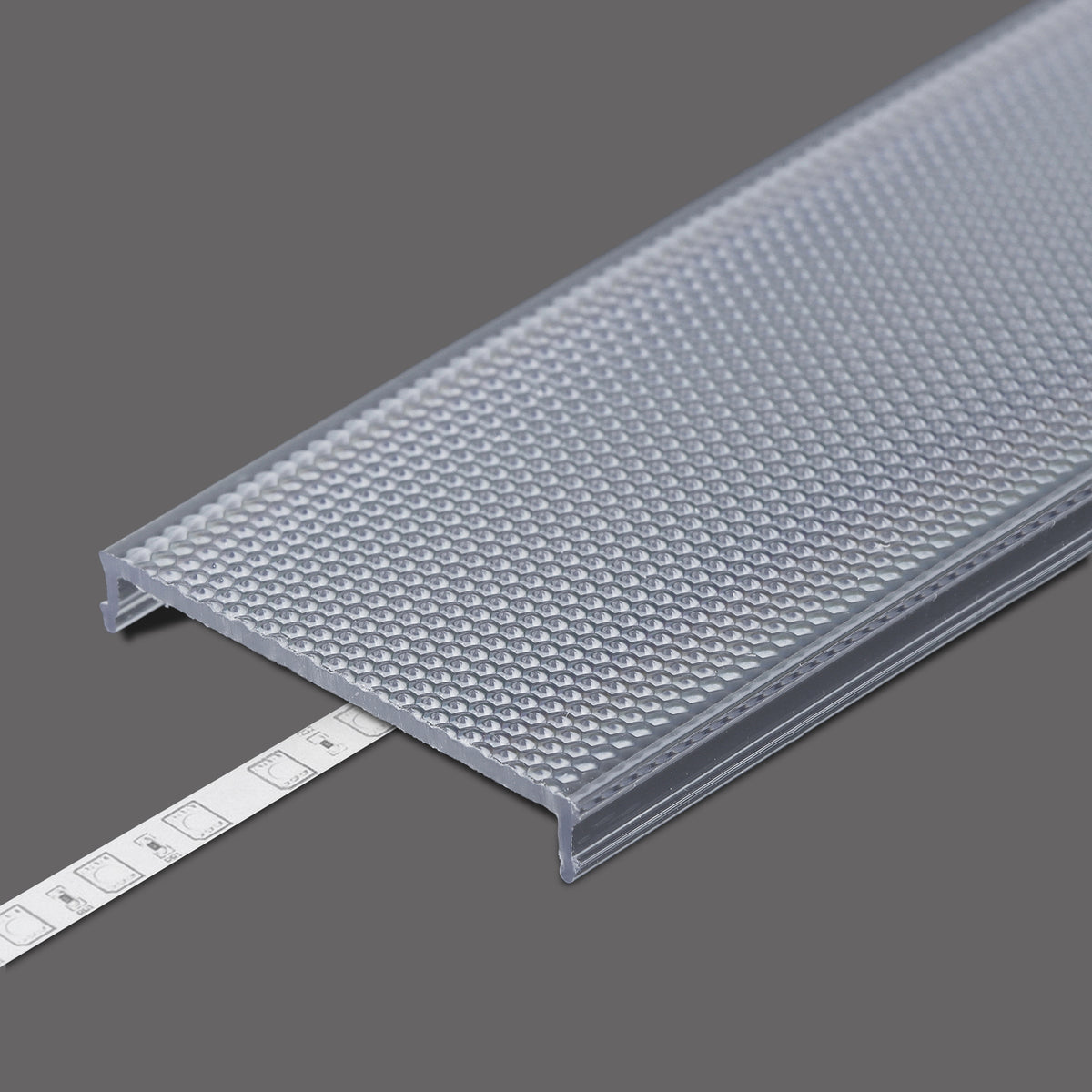 Translucent, textured LED Channel Cover ~ C8 Click with a clip-in design is partially placed over an LED strip light and Pixel33 profiles on a gray background.