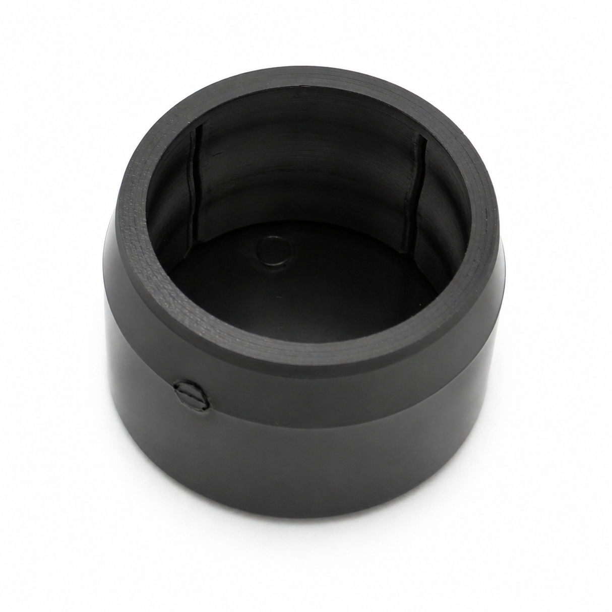 A black cylindrical Structural PVC Joiner for Oslo Tube Profile with a hollow center and side screw, viewed from above on a white background—perfect as a lighting installation accessory.