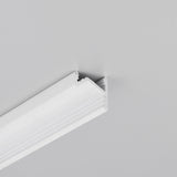 A white crown molding with a decorative edge is mounted where a light gray wall meets the ceiling, creating a clean transition between the two surfaces. The 30/60 Degree Corner LED Channel ~ Model Corner10.v2 can be seamlessly integrated along the molding, providing stylish and functional accent lighting.