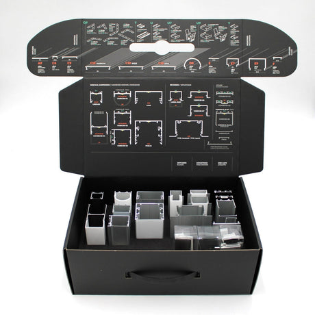 The Topmet LED Channel Sample Case is a black box with assorted metal and plastic channel profiles, including aluminum and lighting samples in compartments and zip bags. The lid features detailed assembly diagrams and identification instructions.